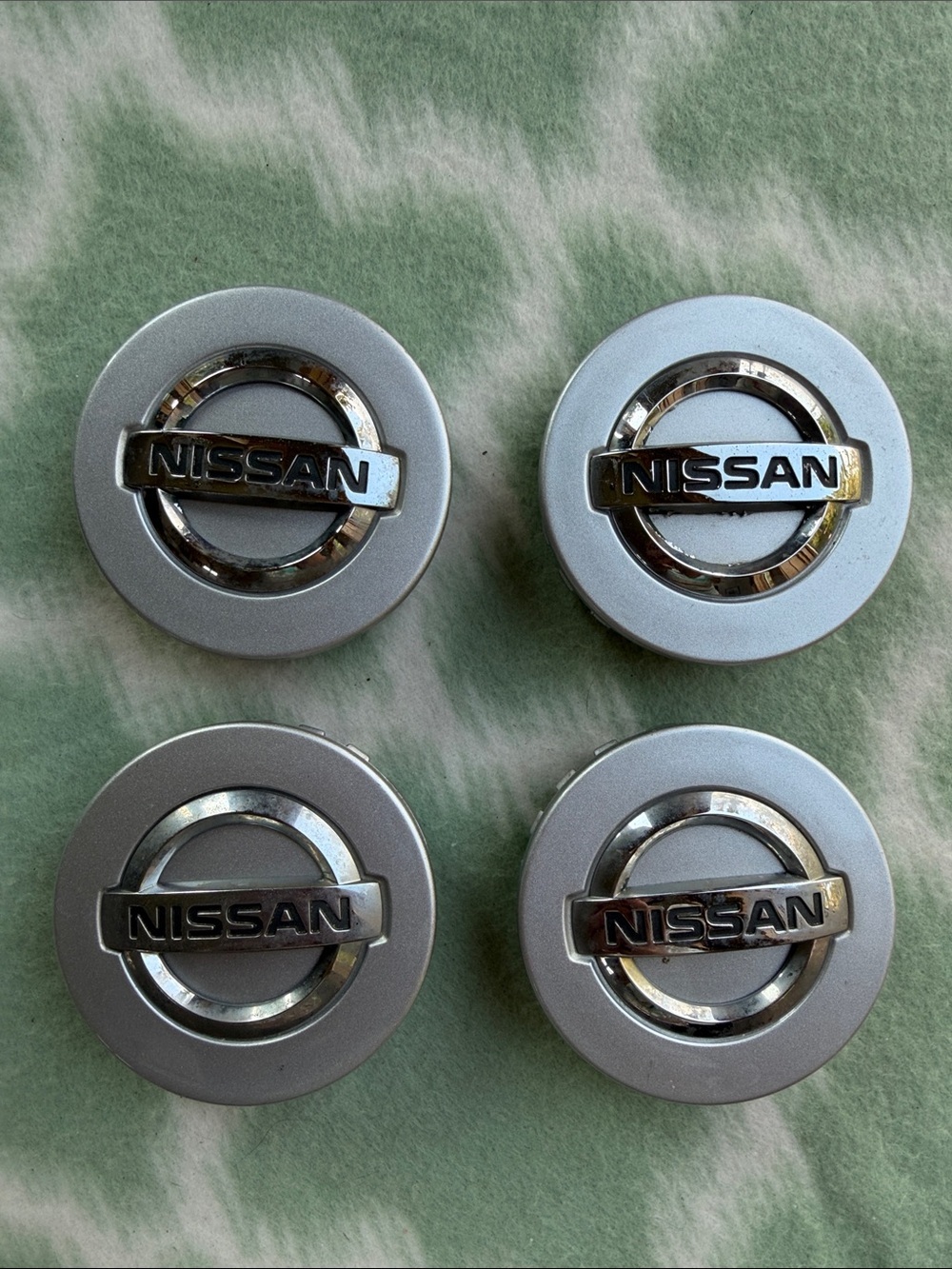 Nissan Silver Chrome Wheel Center Caps Set of 4 - part 40342 - EA210